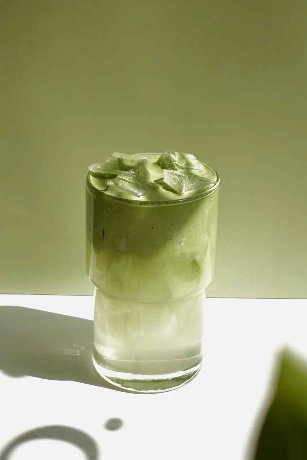 Layered coconut matcha cloud with bright green foam