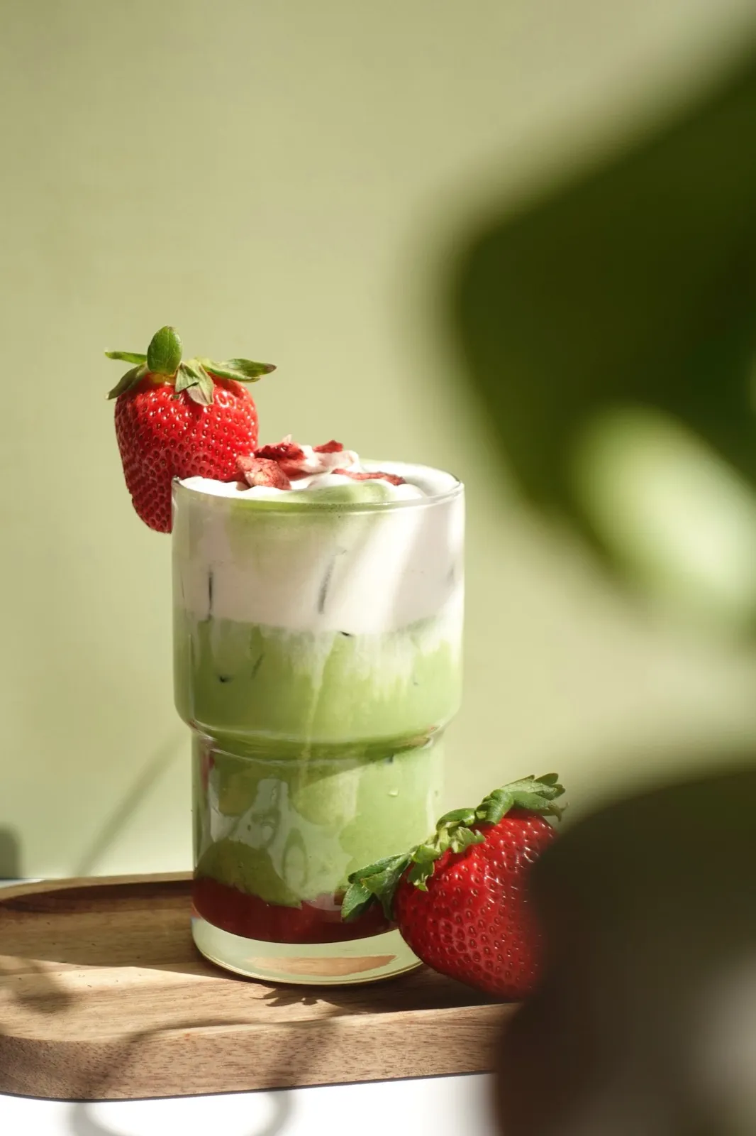 Layered strawberry matcha in a tall glass
